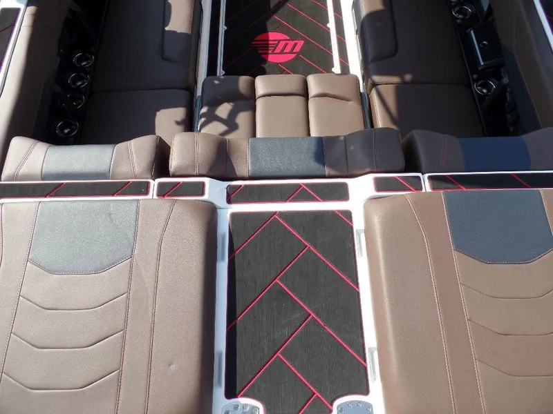 Slide: The Image of 2024 Malibu 23 LSV interior with brown seating and stylish black-red accents. - 6