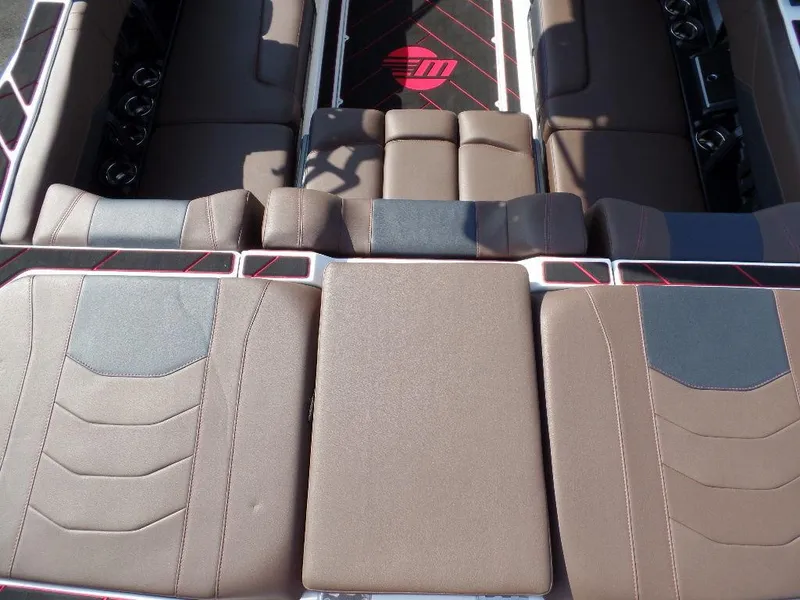 Slide: The Image of 2024 Malibu 23 LSV boat interior with brown seating and stylish design. - 7