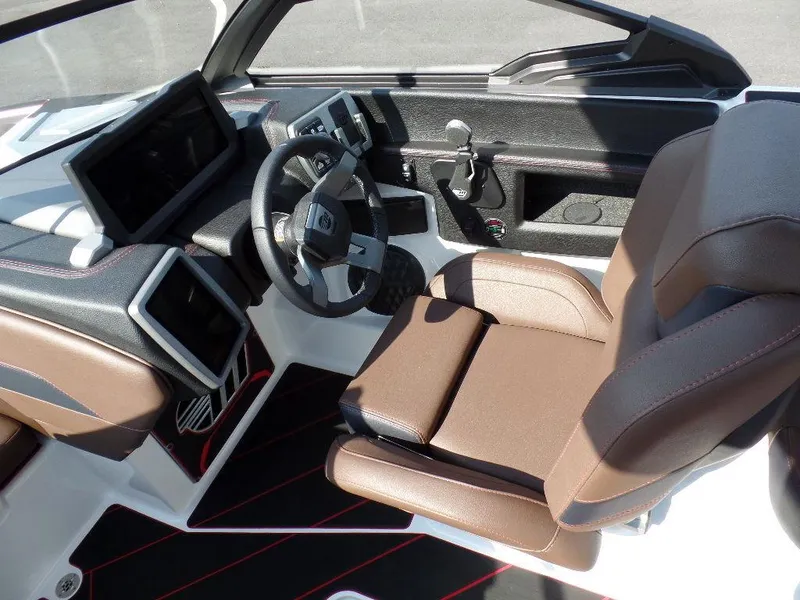 Slide: The Image of 2024 Malibu 23 LSV boat interior with modern dashboard and brown seating. - 8