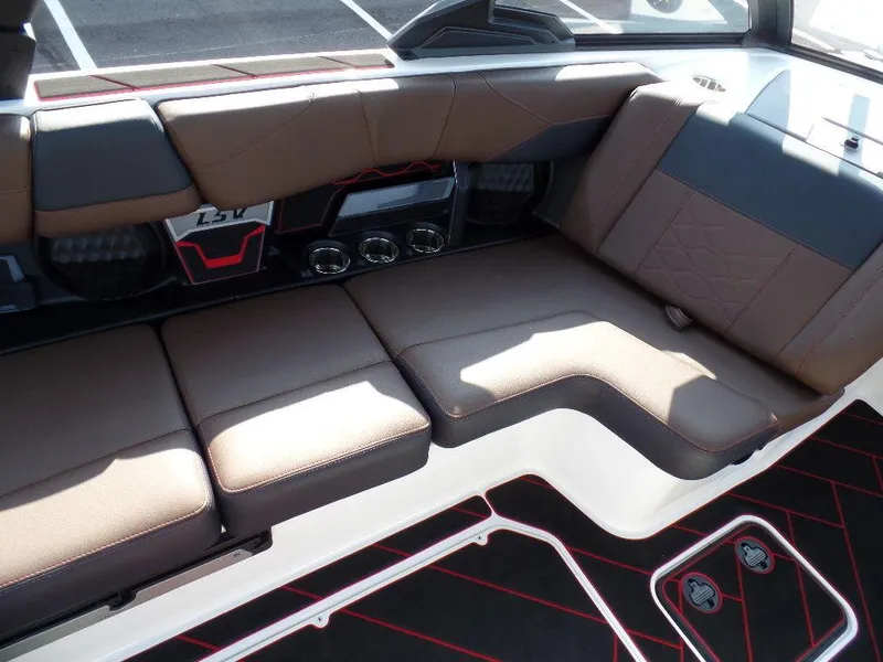 Slide: The Image of 2024 Malibu 23 LSV boat interior with brown seating and modern design. - 9