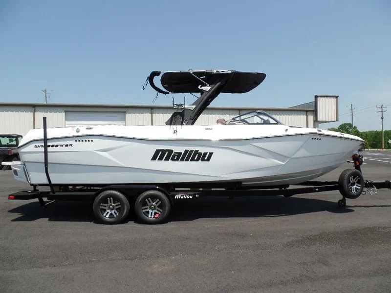 Slide: The Image of 2024 Malibu 26 LSV boat on trailer, parked outdoors. - 1