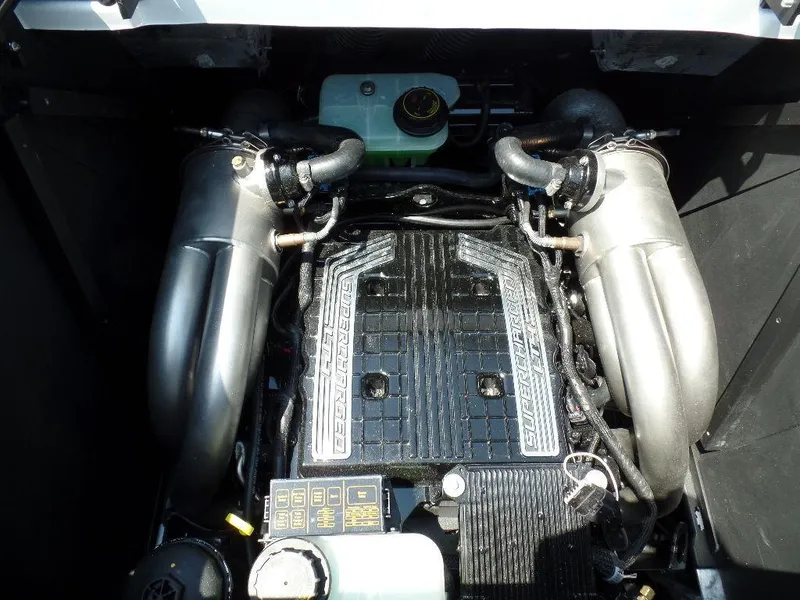 Slide: The Image of 2024 Malibu 26 LSV engine compartment with detailed components and dual exhaust system. - 12