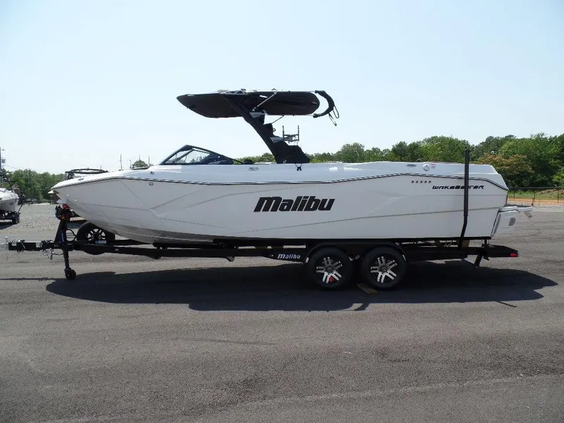 Slide: The Image of 2024 Malibu 26 LSV boat on trailer, side view, outdoors. - 2