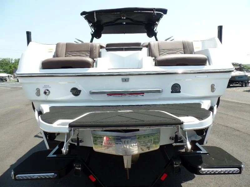 Slide: The Image of 2024 Malibu 26 LSV boat rear view with seating and swim platform. - 3