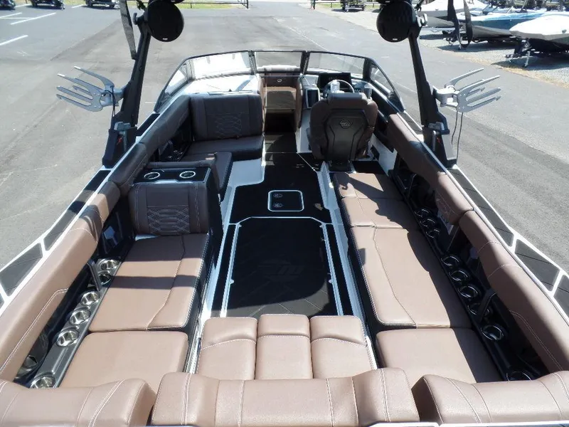 Slide: The Image of 2024 Malibu 26 LSV boat interior with brown seating and modern design. - 5