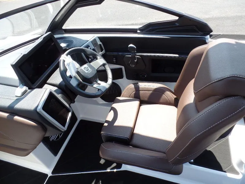 Slide: The Image of 2024 Malibu 26 LSV boat interior with modern dashboard and comfortable seating. - 7