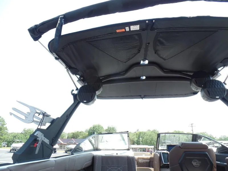 Slide: The Image of 2024 Malibu 26 LSV boat interior with canopy and seating. - 9