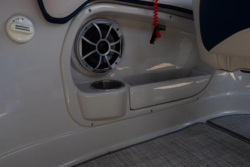 Slide: The Image of 2022 Crownline E 255 XS boat interior with speaker and cup holder. - 13