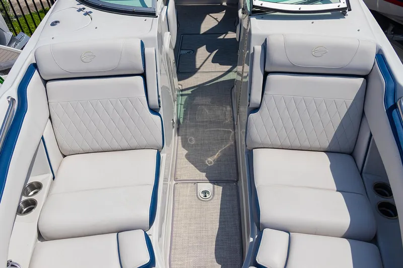 Slide: The Image of 2022 Crownline E 255 XS boat interior with white cushioned seating. - 4
