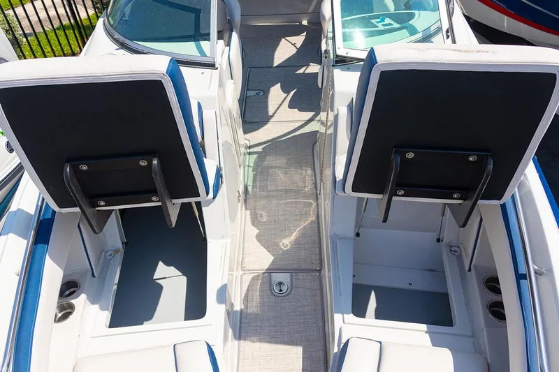 Slide: The Image of 2022 Crownline E 255 XS boat interior with dual seating and center walkway. - 5