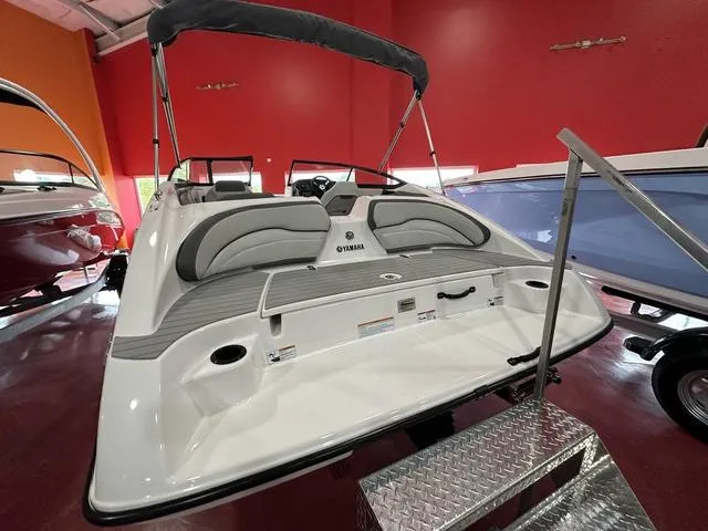 Slide: The Image of 2024 Yamaha Boats SX190, rear view in showroom with red walls. - 3