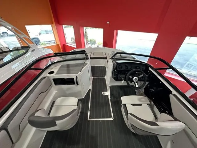 Slide: The Image of 2024 Yamaha Boats SX190 interior, showcasing seating and dashboard in a showroom. - 7