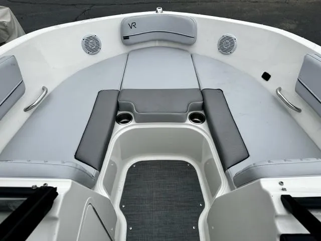 Slide: The Image of 2022 Bayliner VR5 boat bow seating area with gray cushions and cup holders. - 11