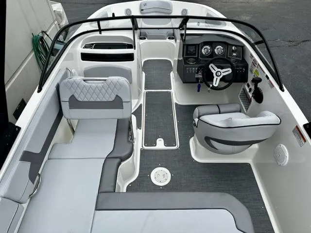 Slide: The Image of 2022 Bayliner VR5 boat interior with seating, steering console, and modern design. - 6