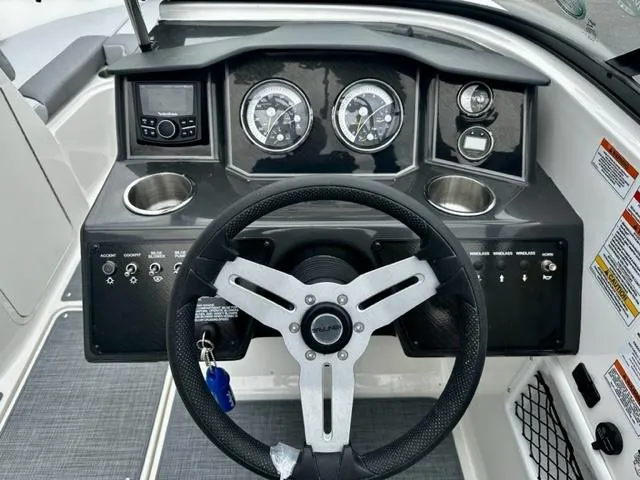 Slide: The Image of 2022 Bayliner VR5 boat dashboard with steering wheel, gauges, and control panel. - 7
