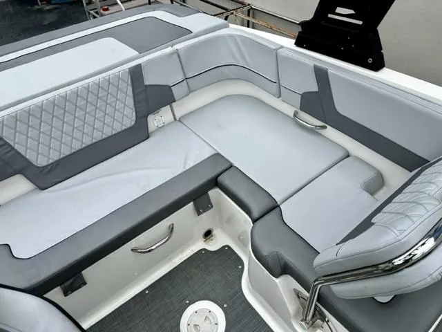 Slide: The Image of 2022 Bayliner VR5 boat interior with gray and white cushioned seating. - 8