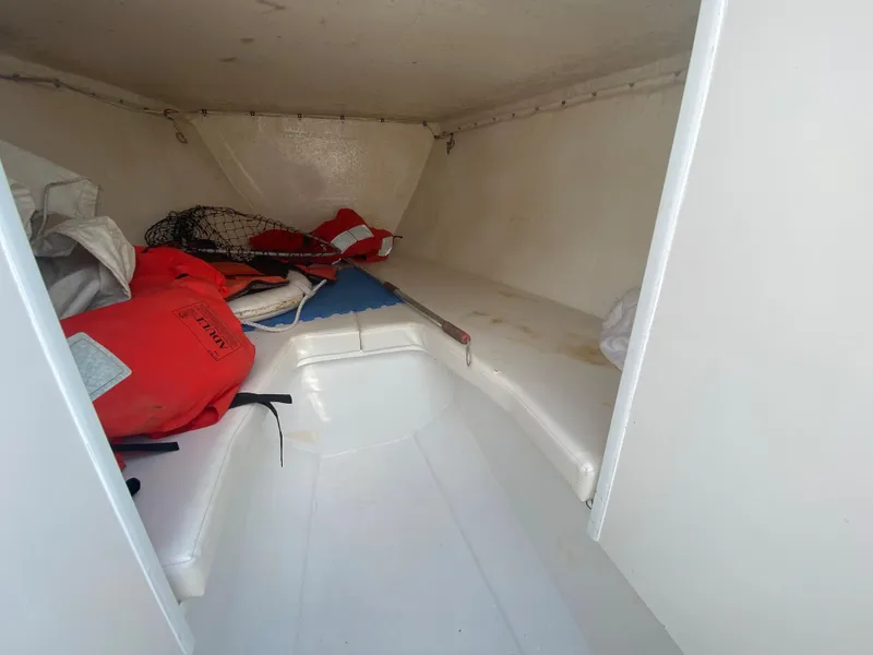 Slide: The Image of 2006 Kryptonite 41 CC boat interior with life jackets and fishing gear. - 12