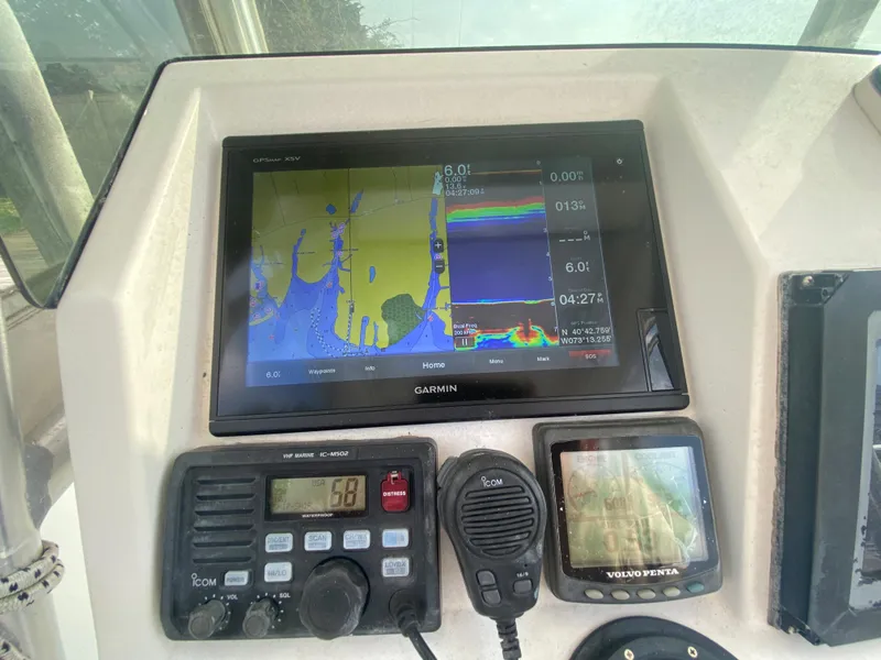 Slide: The Image of Boat dashboard with Garmin GPS, radio, and Volvo Penta display on Kryptonite 41 CC, 2006 model. - 18