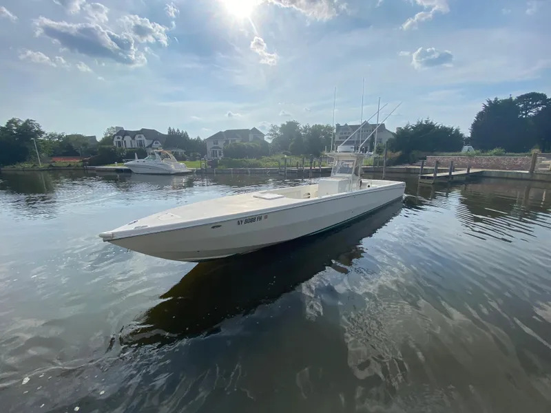 Slide: The Image of 2006 Kryptonite 41 CC boat docked in a serene marina. - 2