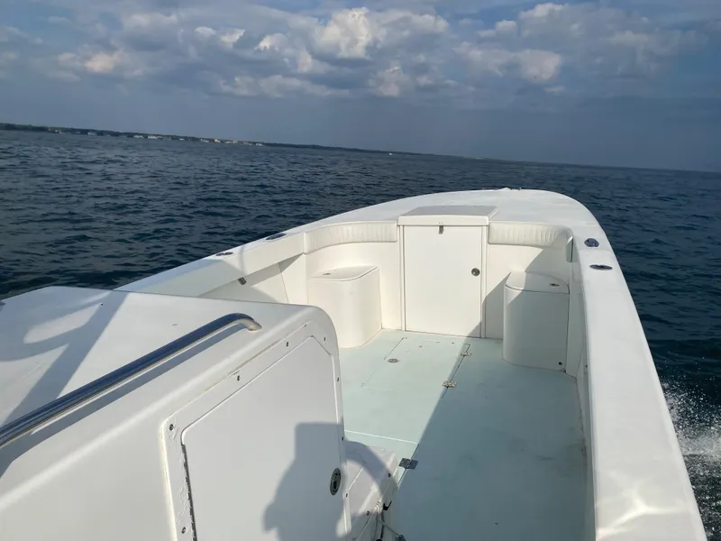 Slide: The Image of 2006 Kryptonite 41 CC boat on open water under a partly cloudy sky. - 20