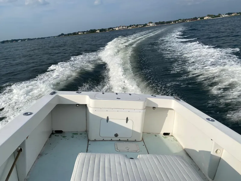 Slide: The Image of 2006 Kryptonite 41 CC boat cruising on open water, view from the stern. - 21