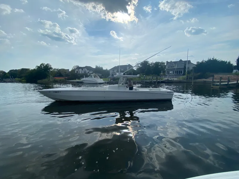 Slide: The Image of 2006 Kryptonite 41 CC boat on calm water near waterfront homes. - 5