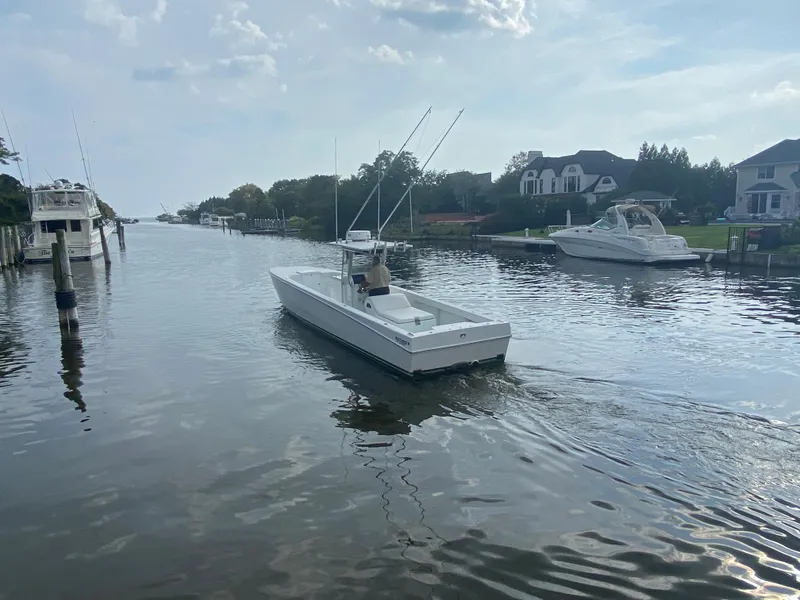 Slide: The Image of 2006 Kryptonite 41 CC boat cruising on a calm residential canal. - 6