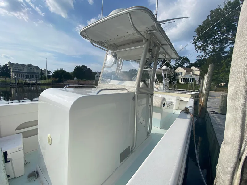 Slide: The Image of 2006 Kryptonite 41 CC boat docked at a marina on a sunny day. - 7