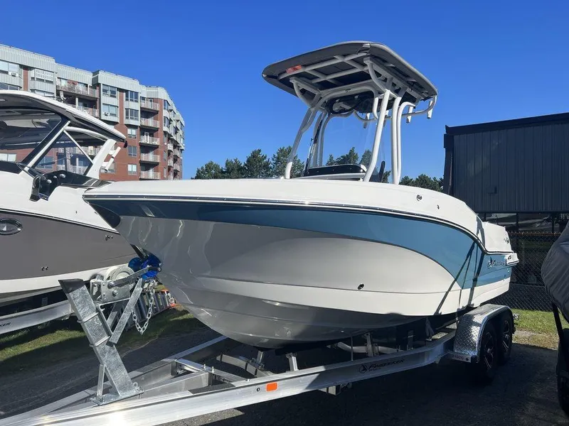 Slide: The Image of 2024 Finseeker 210 FS boat on a trailer, displayed outdoors. - 12