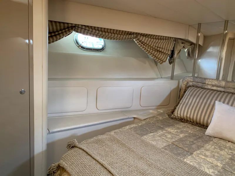 Slide: The Image of Interior cabin of 1998 Magnum 50 Bestia yacht with cozy bedding and window. - 14