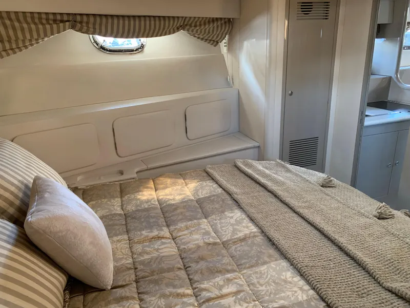 Slide: The Image of Cozy bedroom interior of 1998 Magnum 50 Bestia yacht with elegant bedding and soft lighting. - 15