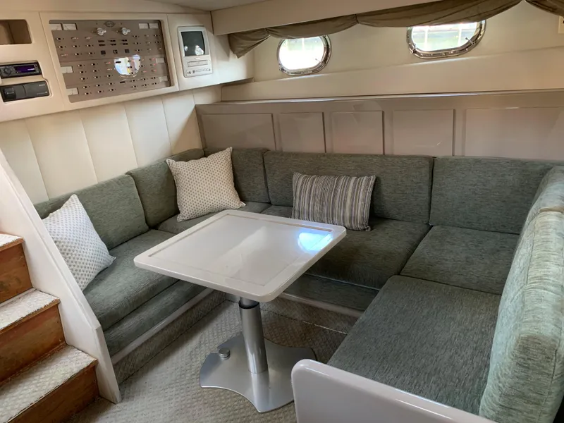 Slide: The Image of Cozy interior of 1998 Magnum 50 Bestia yacht with plush seating and modern table. - 17