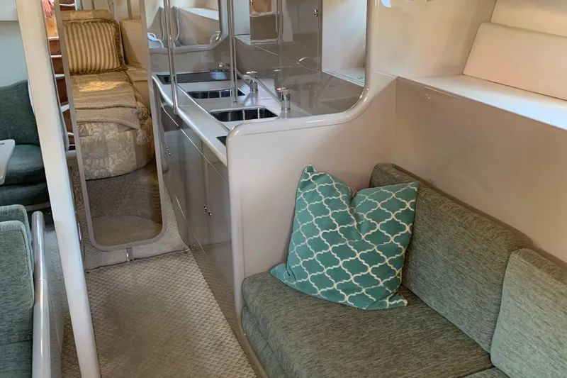 Slide: The Image of Interior of a 1998 Magnum 50 Bestia yacht with cozy seating and modern kitchen area. - 21