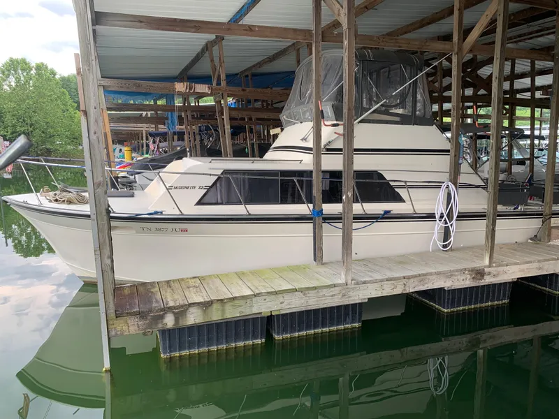 The Image of 1987 Marinette Fisherman boat docked in a covered marina. - 0
