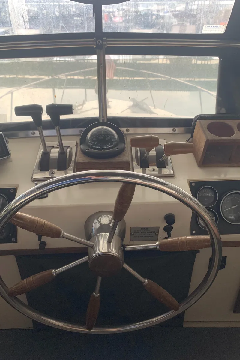 Slide: The Image of 1987 Marinette Fisherman boat helm with steering wheel and control panel. - 12