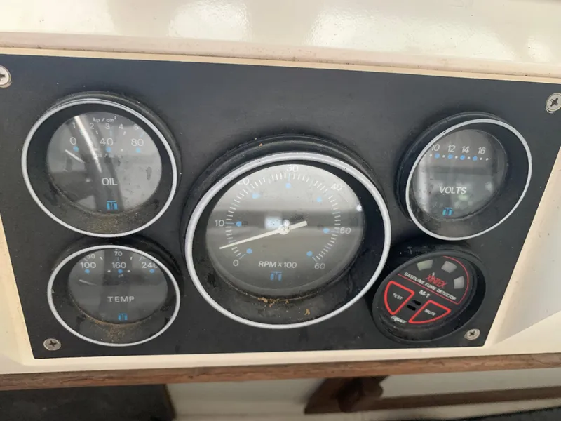 Slide: The Image of 1987 Marinette Fisherman boat dashboard with oil, temperature, RPM, and voltage gauges. - 15