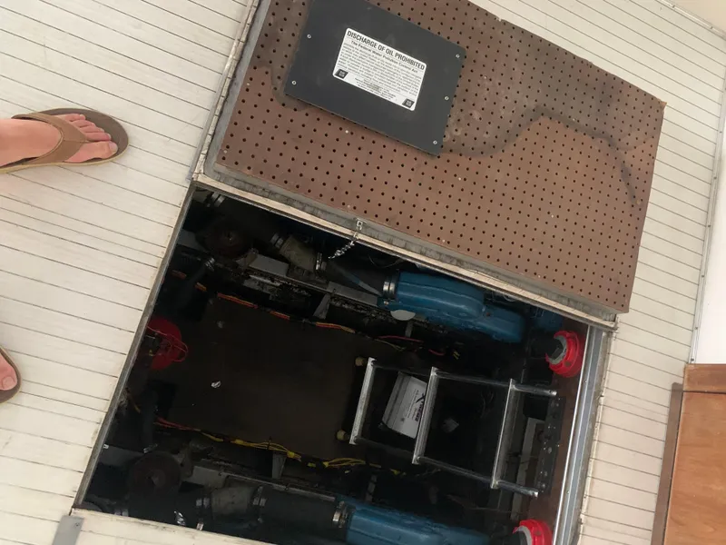 Slide: The Image of Open engine compartment of a 1987 Marinette Fisherman boat with visible machinery. - 16