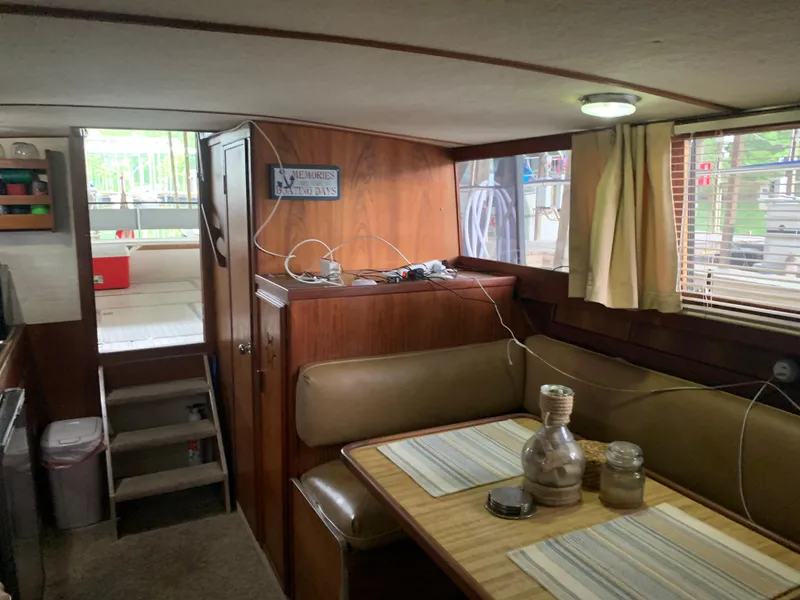Slide: The Image of Interior of a 1987 Marinette Fisherman boat with dining area and stairs. - 20