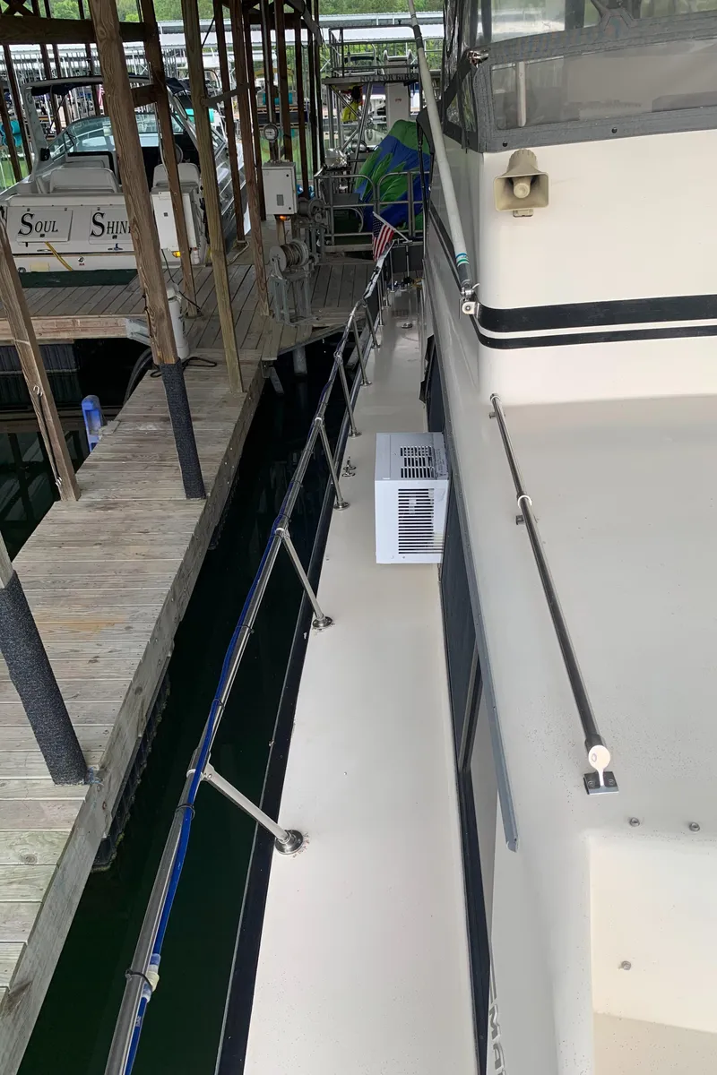 Slide: The Image of 1987 Marinette Fisherman boat docked at a marina. - 22