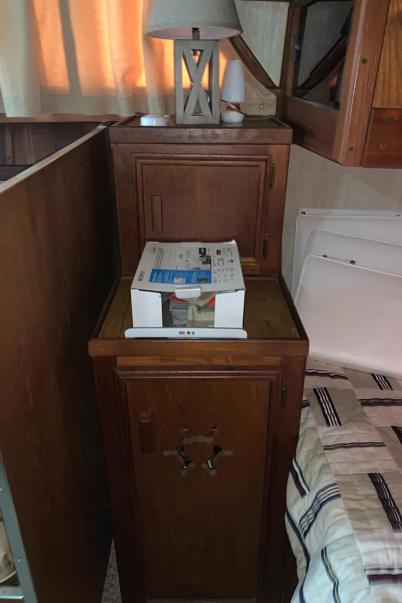 Slide: The Image of Wooden interior of 1987 Marinette Fisherman boat with lamp and box on cabinet. - 23