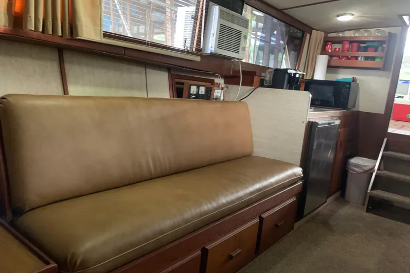 Slide: The Image of 1987 Marinette Fisherman boat interior with leather seating and kitchenette. - 25