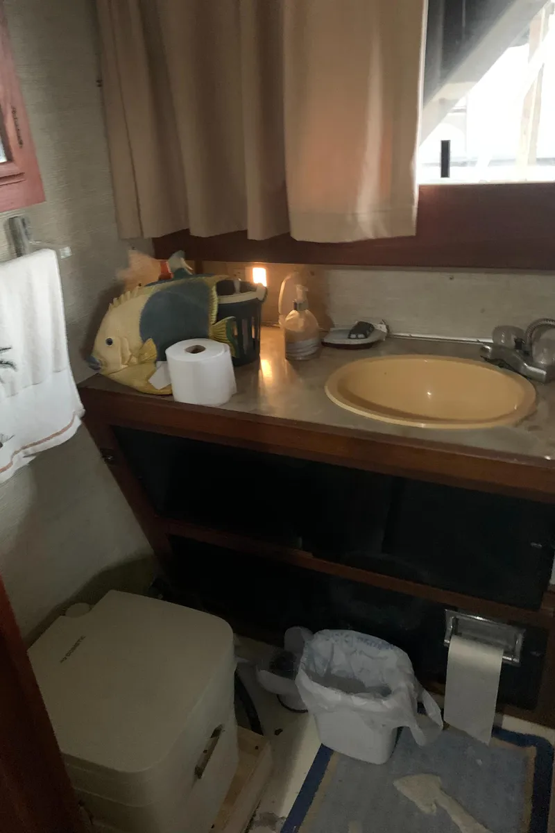 Slide: The Image of 1987 Marinette Fisherman boat bathroom with sink, toilet, and toiletries. - 26