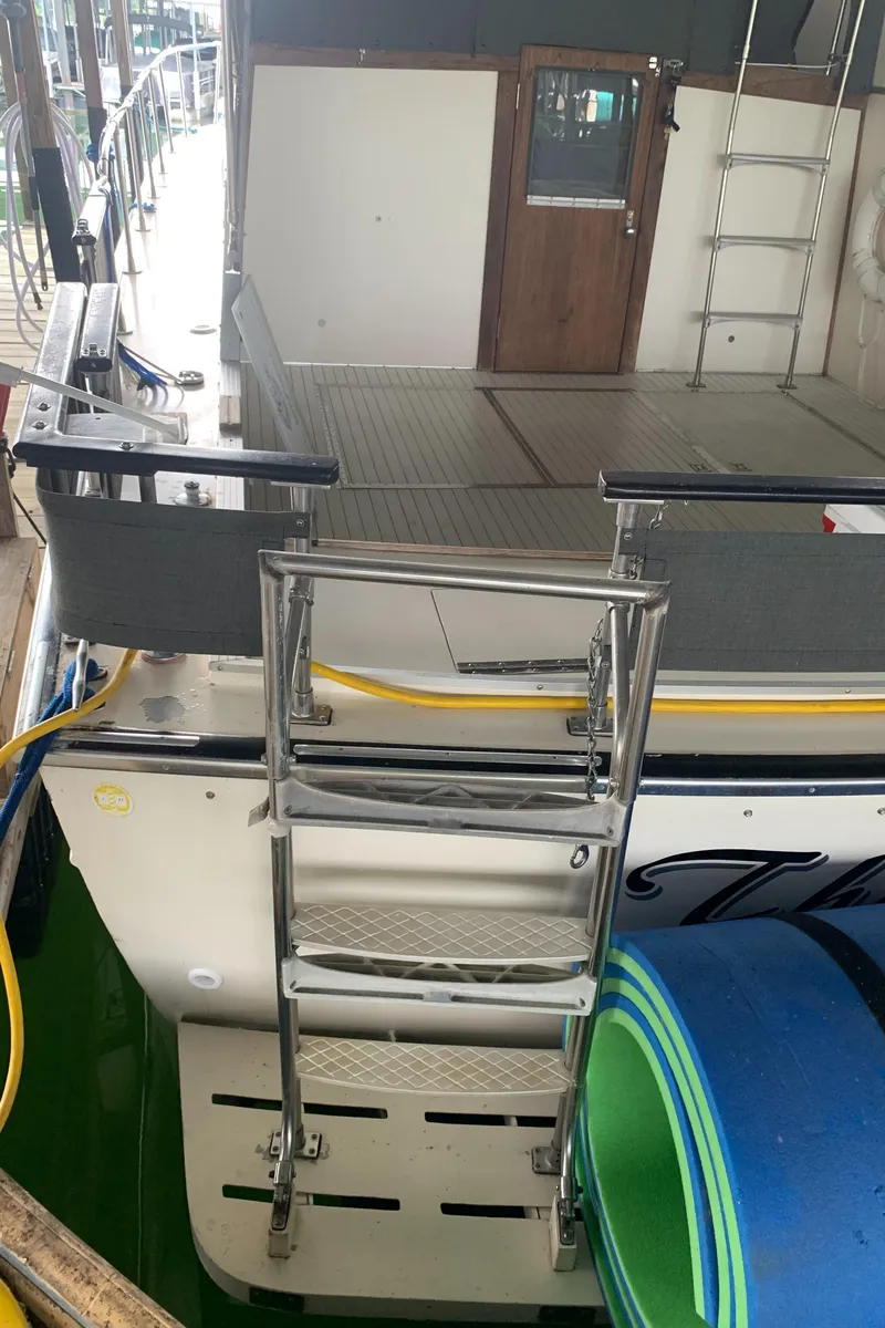 Slide: The Image of 1987 Marinette Fisherman boat with rear ladder and deck view. - 7