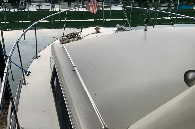 Slide: The Image of 1987 Marinette Fisherman boat deck with railing and mooring ropes. - 9