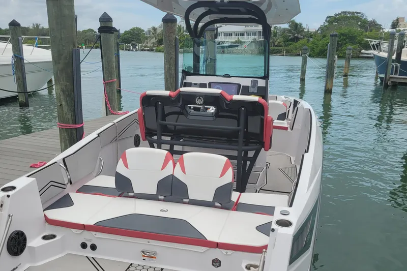 Slide: The Image of 2019 Scarab 255 Open ID boat docked at marina, rear seating view. - 30