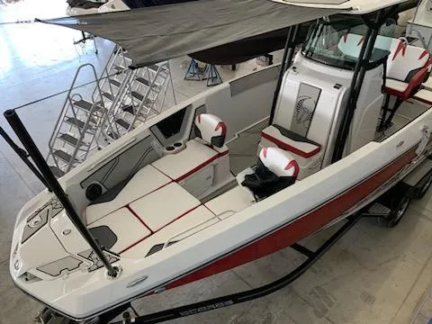 Slide: The Image of 2019 Scarab 255 Open ID boat with red and white interior, docked indoors. - 32