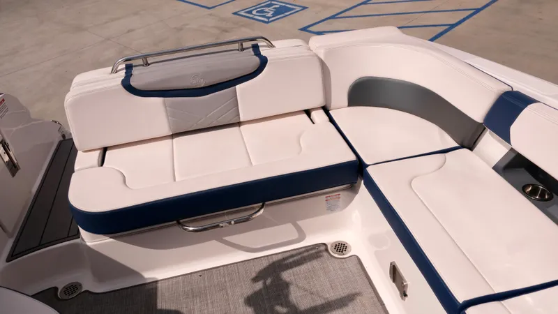 Slide: The Image of 2021 Chaparral 30 Surf boat interior seating area with white and blue upholstery. - 11