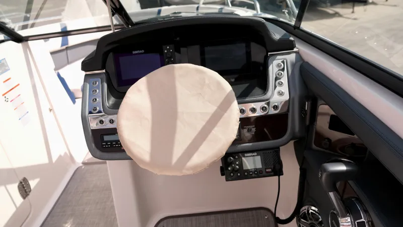 Slide: The Image of Cockpit of 2021 Chaparral 30 Surf boat with covered steering wheel and modern controls. - 16