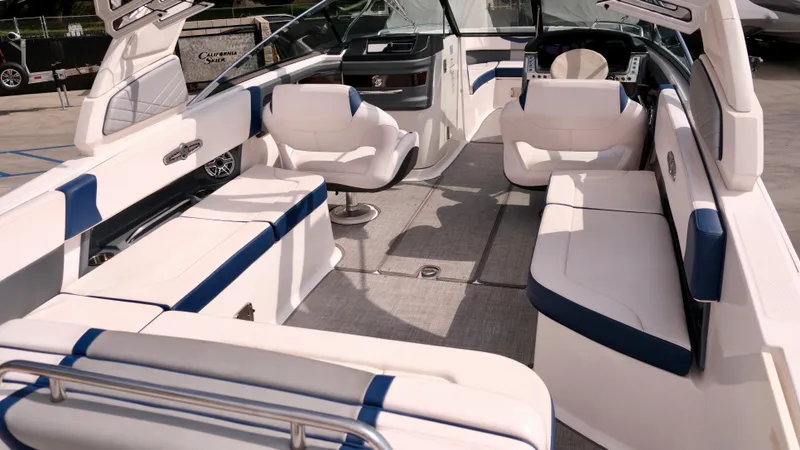Slide: The Image of 2021 Chaparral 30 Surf boat interior with white and blue seating. - 9