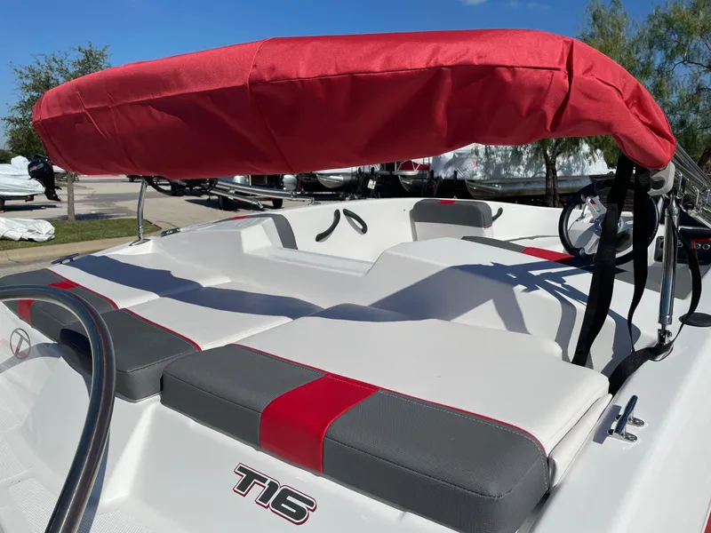 Slide: The Image of 2024 Tahoe T16 boat with red canopy and sleek seating design. - 12